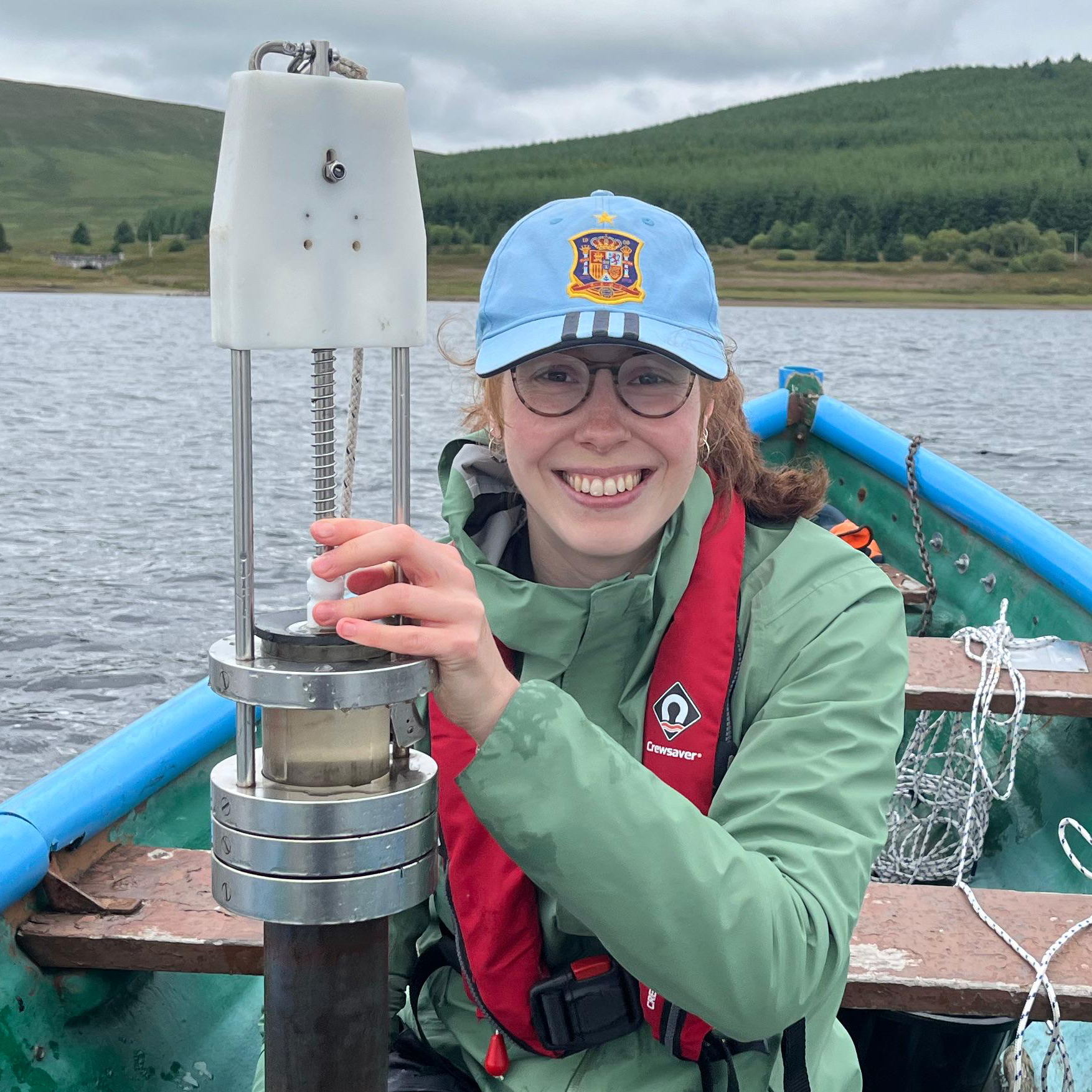 Helene Engler collecting sediment in a boat on Daer Reservoir.